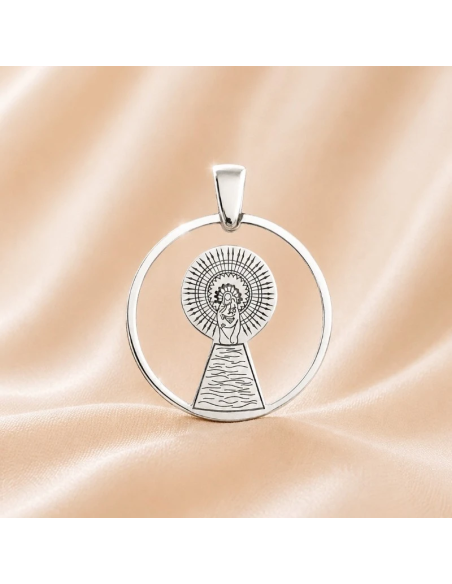 Round silver medal featuring an engraved image of Our Lady of the Pillar with a polished finish.